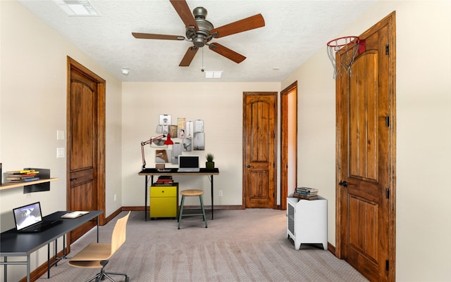 office area featuring light carpet, baseboards, visible vents, and a textured ceiling