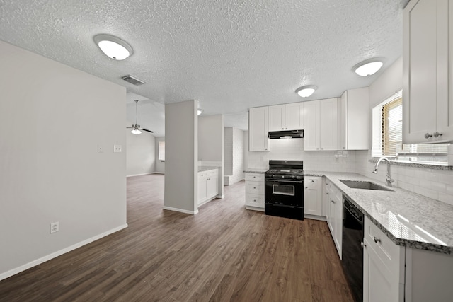 kitchen with sink, dark hardwood / wood-style flooring, tasteful backsplash, range with gas cooktop, and white cabinets