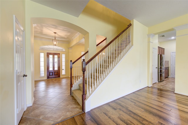 foyer entrance featuring light wood-type flooring and ornamental molding