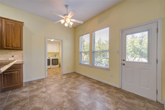 interior space with ceiling fan, decorative backsplash, light stone countertops, and washer and dryer