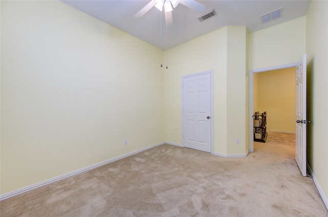 unfurnished bedroom with light carpet and ceiling fan