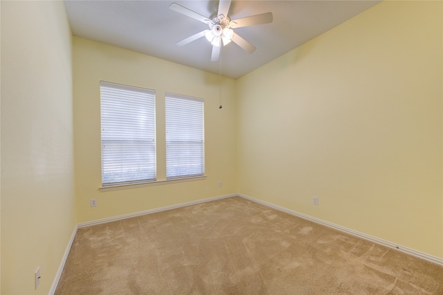 carpeted spare room featuring ceiling fan