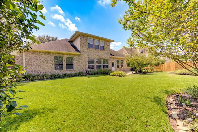 back of property featuring a lawn