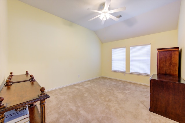 interior space with ceiling fan, light colored carpet, and vaulted ceiling