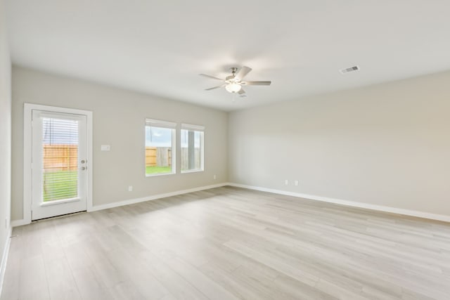 spare room with light wood-type flooring and ceiling fan