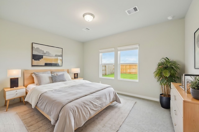 bedroom featuring light colored carpet