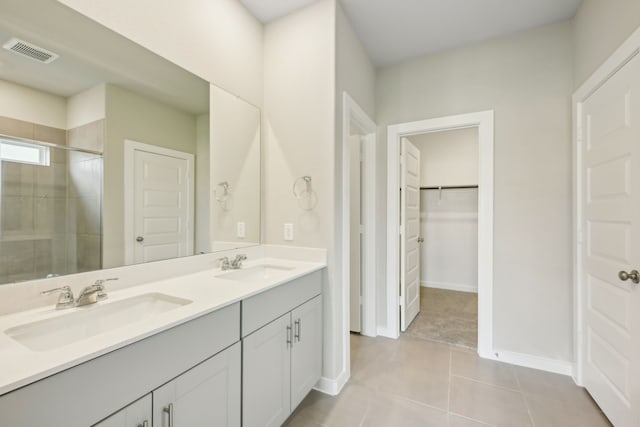 bathroom featuring an enclosed shower, vanity, and tile patterned floors