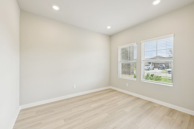 unfurnished room with light hardwood / wood-style floors