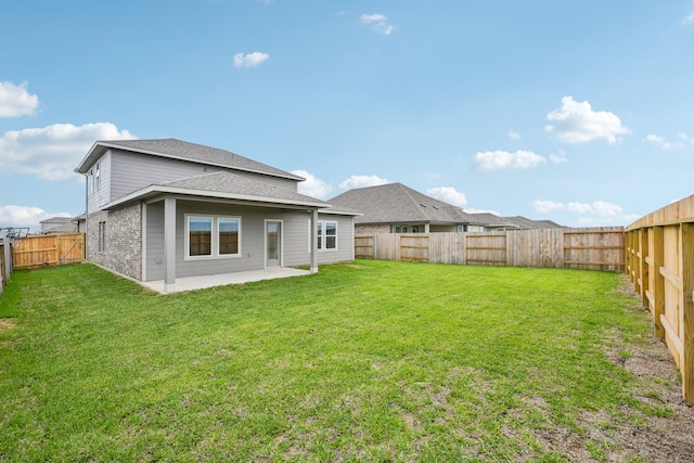 rear view of property with a patio and a yard