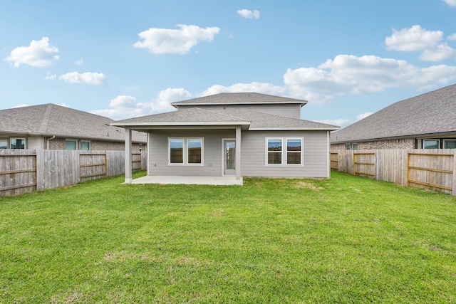 back of house featuring a patio area and a yard