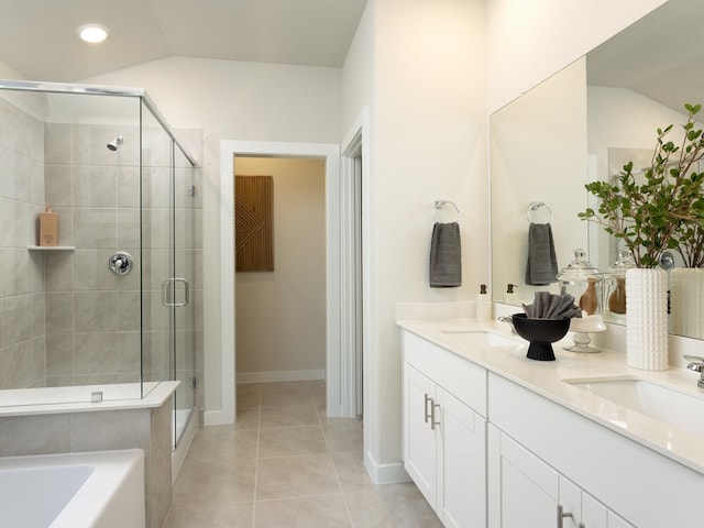 bathroom featuring plus walk in shower, vaulted ceiling, vanity, and tile patterned floors