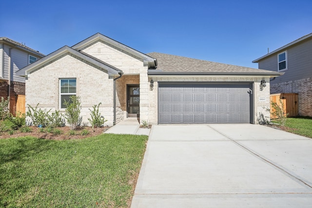 view of front of property with a garage and a front lawn