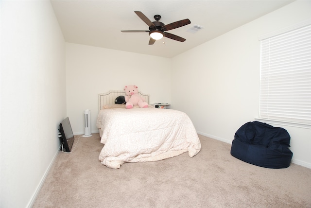 bedroom with ceiling fan and light colored carpet