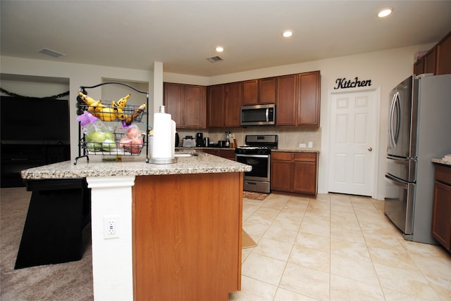 kitchen with stainless steel appliances and light stone countertops