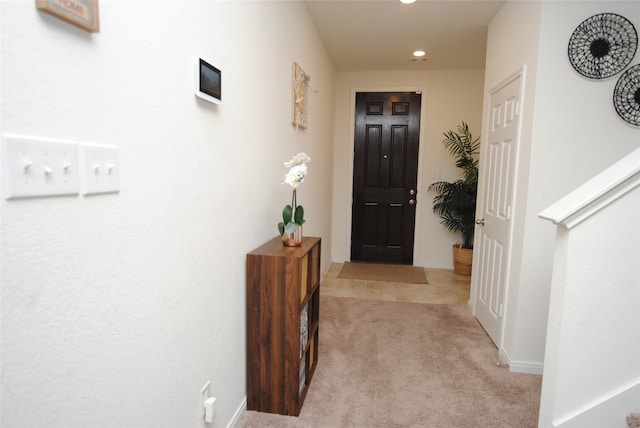 hallway with light colored carpet