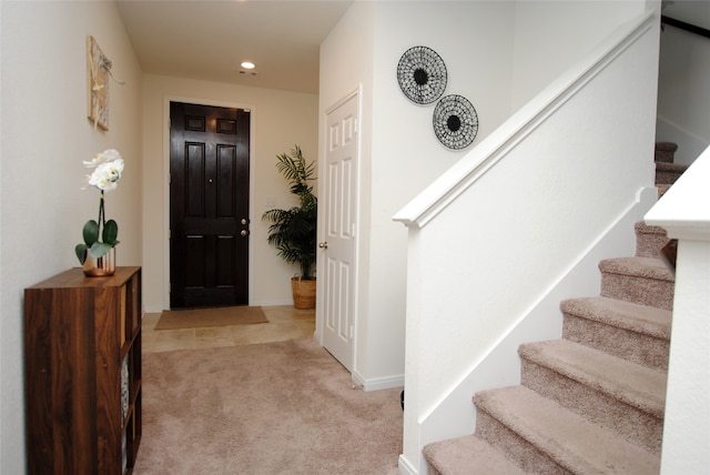 foyer entrance featuring light colored carpet