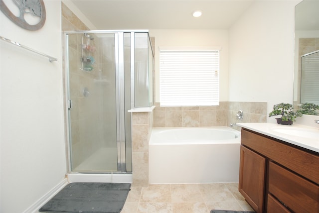 bathroom featuring tile patterned flooring, shower with separate bathtub, and vanity