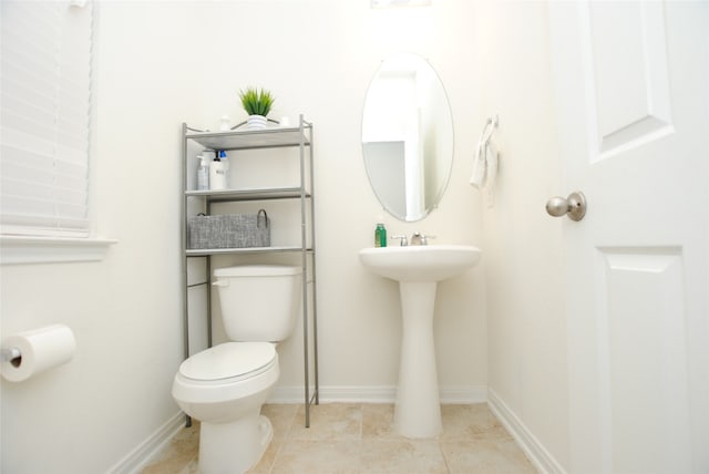 bathroom with toilet and tile patterned flooring