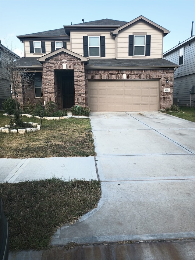 view of front of home featuring a garage and a front lawn