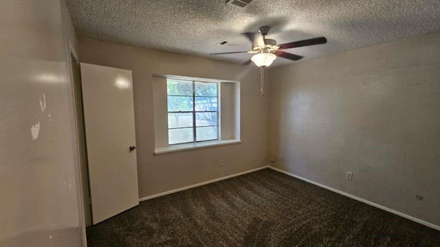 empty room featuring carpet floors, ceiling fan, a textured ceiling, and baseboards