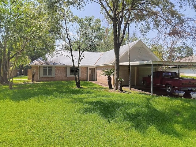 back of house featuring a lawn and a carport