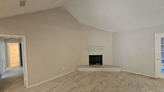 unfurnished living room featuring high vaulted ceiling, a brick fireplace, baseboards, and light colored carpet