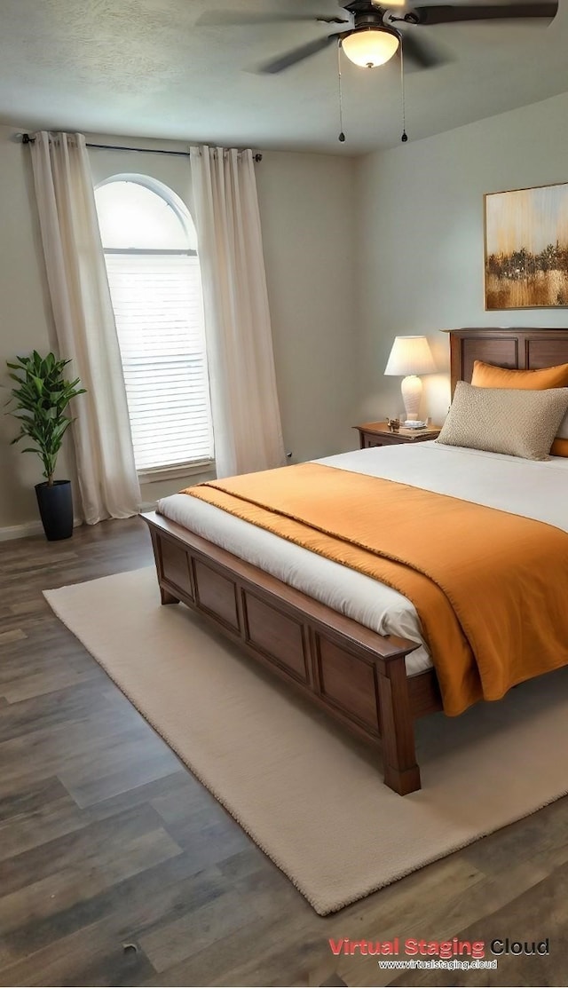 bedroom with dark hardwood / wood-style floors and ceiling fan