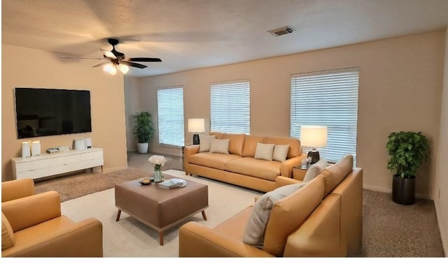 carpeted living room featuring ceiling fan