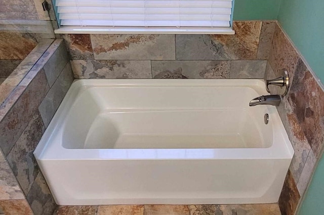 bathroom with tiled tub