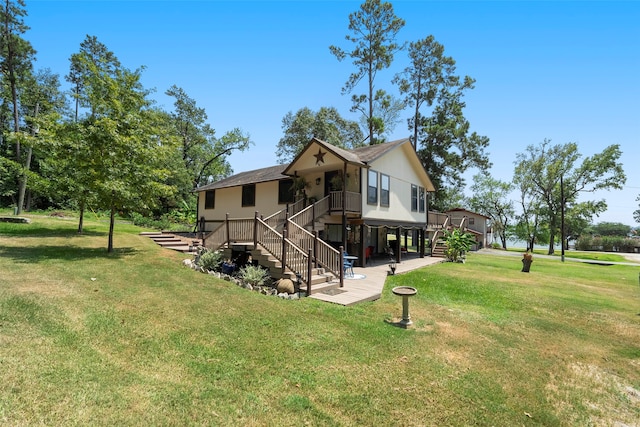 rear view of house featuring a yard