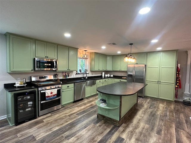 kitchen featuring dark hardwood / wood-style flooring, green cabinetry, appliances with stainless steel finishes, and wine cooler