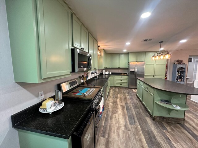 kitchen featuring a center island, dark hardwood / wood-style flooring, appliances with stainless steel finishes, hanging light fixtures, and green cabinetry