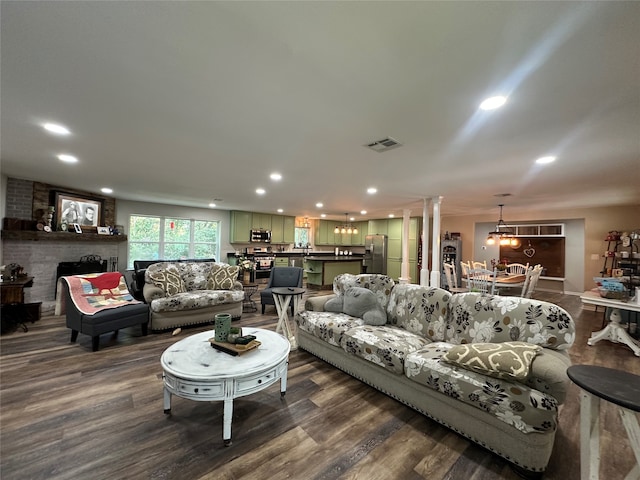 living room featuring hardwood / wood-style floors and ornate columns