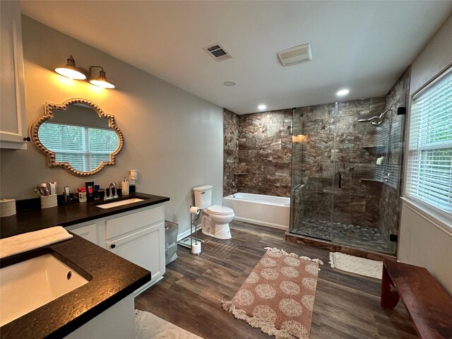 full bathroom featuring toilet, shower with separate bathtub, vanity, and hardwood / wood-style flooring