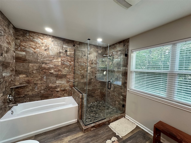 bathroom with hardwood / wood-style floors and plus walk in shower