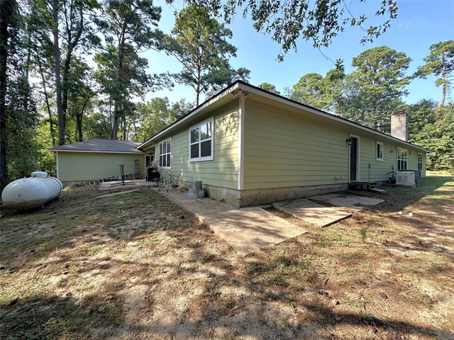 view of side of property featuring a patio