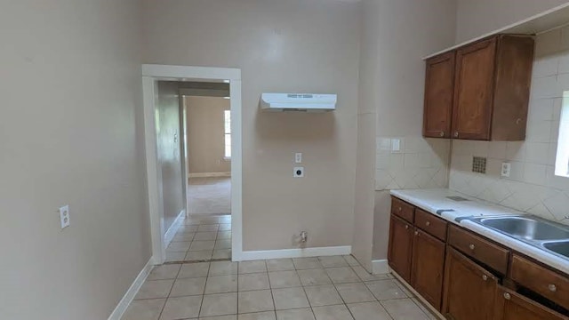 kitchen featuring decorative backsplash and light tile patterned flooring