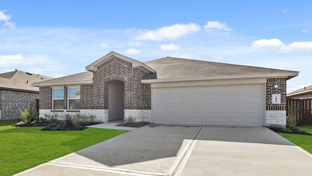 single story home with a garage and a front lawn