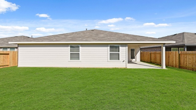 back of house with a lawn and a patio area