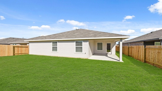 rear view of house featuring a lawn and a patio area