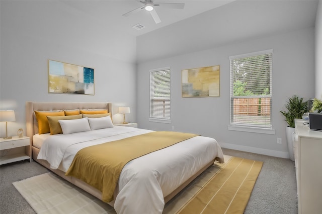 carpeted bedroom featuring ceiling fan and vaulted ceiling