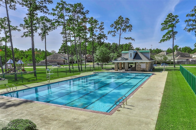 view of swimming pool with a lawn