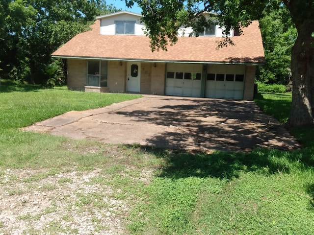 view of front of home with a garage and a front yard