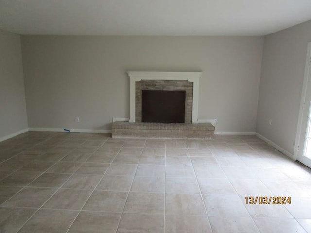 unfurnished living room with tile patterned floors and a fireplace