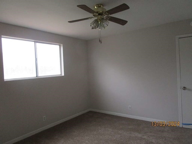 carpeted spare room with ceiling fan