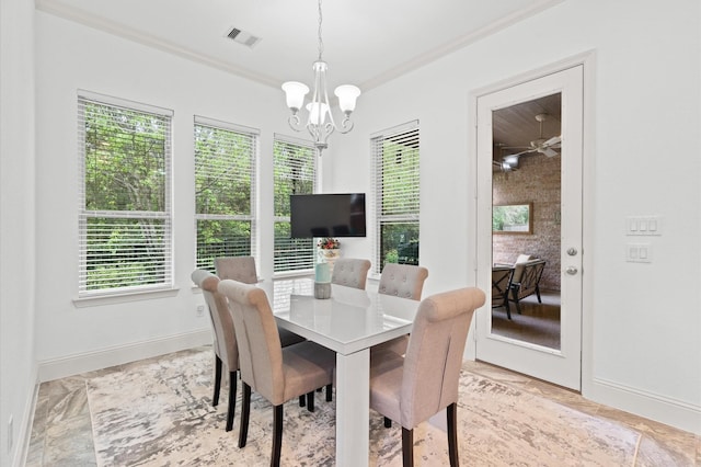 dining area featuring plenty of natural light, a notable chandelier, and ornamental molding