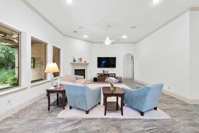 tiled living room with ceiling fan and ornamental molding