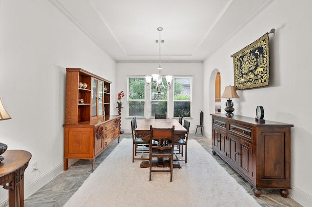 dining space with a tray ceiling, tile patterned floors, and a chandelier