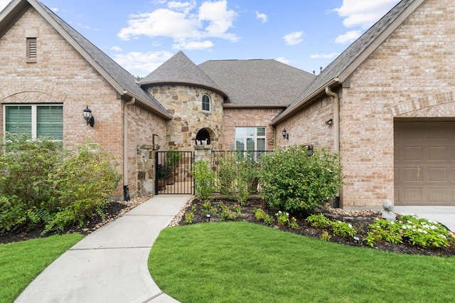 view of front of house featuring a front yard and a garage