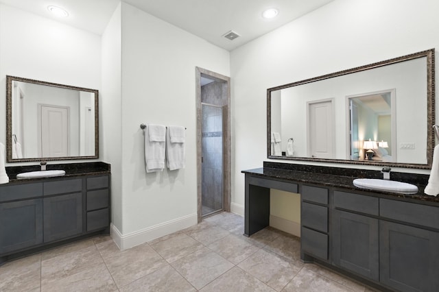 bathroom featuring tile patterned flooring, an enclosed shower, and vanity